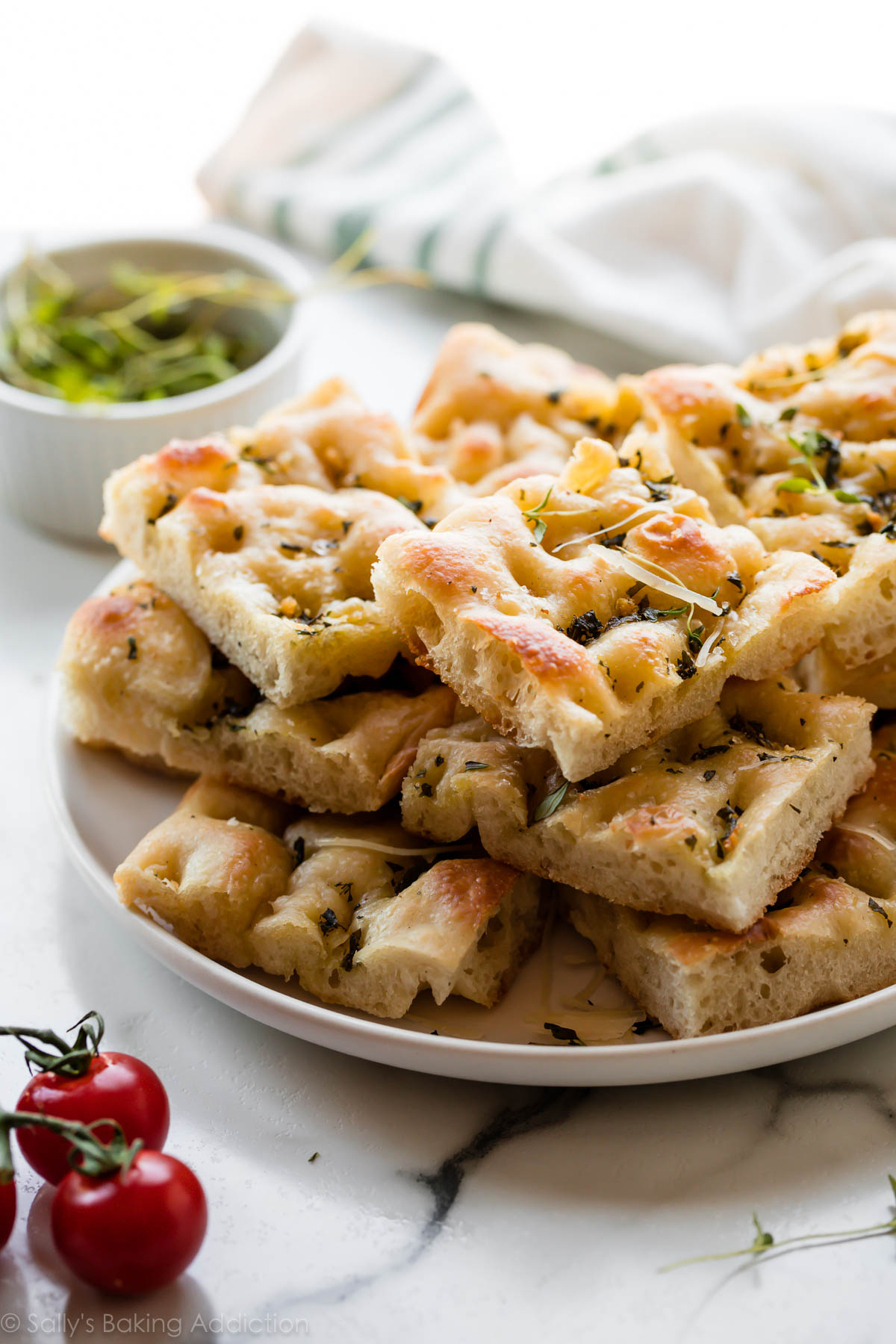 Garlic rosemary herb focaccia bread on serving plate
